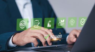 ISO 14001 concept. Businessman use laptop with ISO 14001 certified for environmental management systems (EMS). Identify, control and reduce the environmental impact of activities.