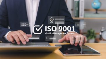 ISO 9001 Standard certification standardisation quality control concept, Certified and quality, Businessman use computer and tablet with text ISO 9001 for quality management of organizations.